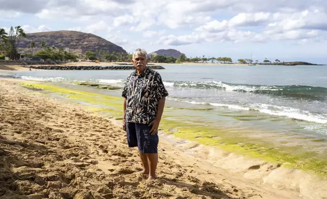 Cultural practitioner Glen Kila poses for a portrait near the shoreline where ancient petroglyphs at Pokai Bay, July 22, 2025, in Waianae, Hawaii. (AP Photo/Mengshin Lin)