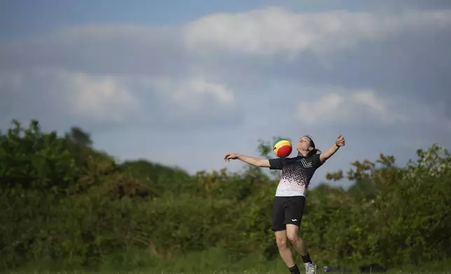 Transgender soccer player Natalie Washington, who leads the group "Football v Transphobia", takes part in a casual kickaround with some friends in Guildford, England, Thursday, May 8, 2025. (AP Photo/Alastair Grant)