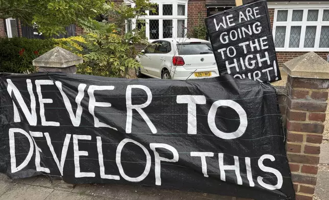 A banner opposed to Wimbledon's major expansion plan is placed outside a house leading to the All England Club where the Wimbledon Tennis Championships take place in London, Saturday, July 5, 2025. (AP Photo/Tony Hicks)