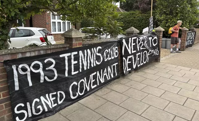 A banner opposed to Wimbledon's major expansion plan is placed outside a house leading to the All England Club where the Wimbledon Tennis Championships take place in London, Saturday, July 5, 2025. (AP Photo/Tony Hicks)