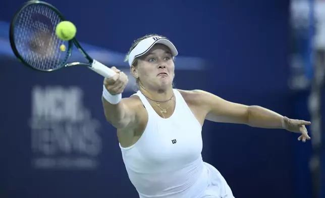 Peyton Stearns returns the ball against Venus Williams during a match at the Citi Open tennis tournament Tuesday, July 22, 2025, in Washington. (AP Photo/Nick Wass)