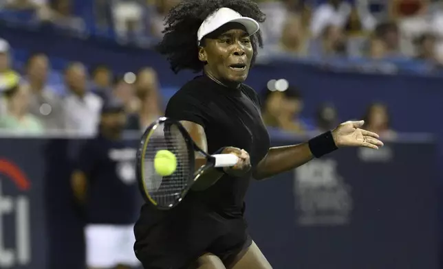 Venus Williams returns the ball against Peyton Stearns during a match at the Citi Open tennis tournament Tuesday, July 22, 2025, in Washington. (AP Photo/Nick Wass)