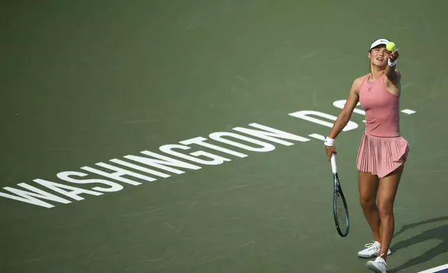 Emma Raducanu, of Britain, serves to Marta Kostyuk, of Ukraine, during a match at the Citi Open tennis tournament Tuesday, July 22, 2025, in Washington. (AP Photo/Nick Wass)