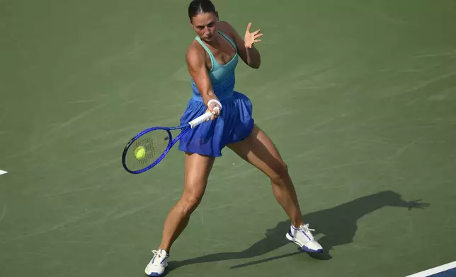 Marta Kostyuk, of Ukraine, returns the ball to Emma Raducanu, of Britain, during a match at the Citi Open tennis tournament Tuesday, July 22, 2025, in Washington. (AP Photo/Nick Wass)