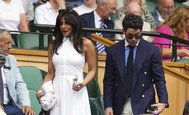 Indian actress Priyanka Chopra and her husband Nick Jonas arrive in the Royal Box at Centre Court during the Wimbledon Tennis Championships in London, Wednesday, July 2, 2025.(AP Photo/Kirsty Wigglesworth)