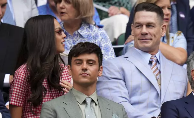 Singer Olivia Rodrigo, left, Olympic gold medallist Tom Daley, center, and wrestler John Cena sit in the Royal Box at Centre Court during the Wimbledon Tennis Championships in London, Wednesday, July 2, 2025.(AP Photo/Kirsty Wigglesworth)