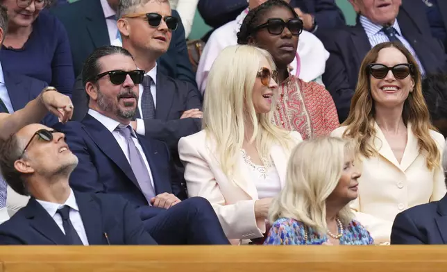 Musician Dave Grohl his wife Jordyn, centre, and actor Leslie Mann sit in the Royal Box at Centre Court during the Wimbledon Tennis Championships in London, Wednesday, July 2, 2025.(AP Photo/Kirsty Wigglesworth)