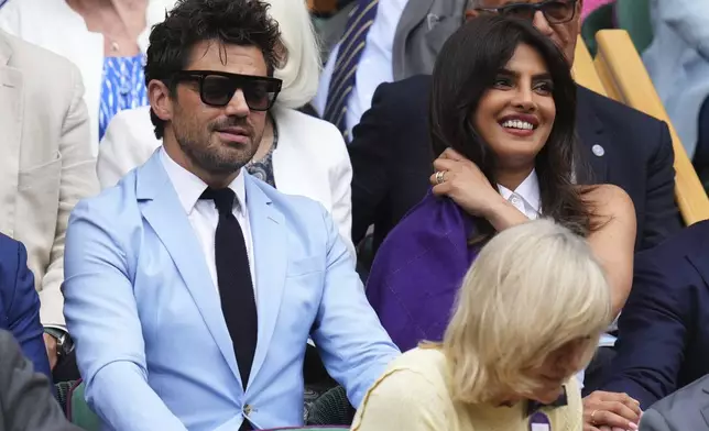 Indian actress Priyanka Chopra, right, and English actor Dominic Cooper sit in the Royal Box at Centre Court during the Wimbledon Tennis Championships in London, Wednesday, July 2, 2025.(AP Photo/Kirsty Wigglesworth)