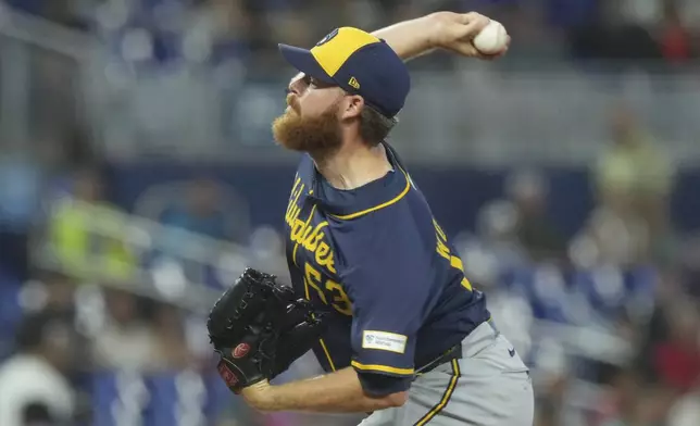 Milwaukee Brewers pitcher Brandon Woodruff aims a pitch during the second inning of a baseball game against the Miami Marlins, Sunday, July 6, 2025, in Miami. (AP Photo/Marta Lavandier)