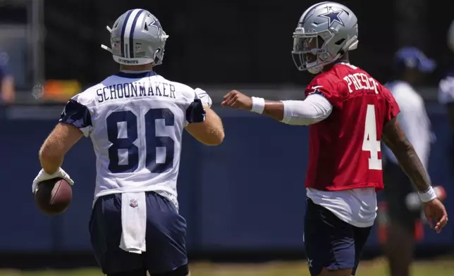 Dallas Cowboys tight end Luke Schoonmaker, left, is congratulated by quarterback Dak Prescott after catching a pass during training camp Tuesday, July 22, 2025, in Oxnard, Calif. (AP Photo/Mark J. Terrill)