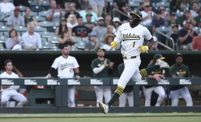 Athletics' Denzel Clarke scores on a double hit by Lawrence Butler during the third inning of a baseball game against the Toronto Blue Jays, Saturday, July 12, 2025, in West Sacramento, Calif. (AP Photo/Sara Nevis)