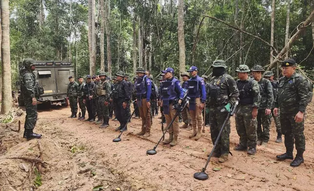 In this Sunday, July, 2025, photo released by the Royal Thai Army, Thai soldiers inspect a border area in Ubon Ratchathani†province where the Royal Thai Army said two anti-personnel landmines were found. (Royal Thai Army via AP)