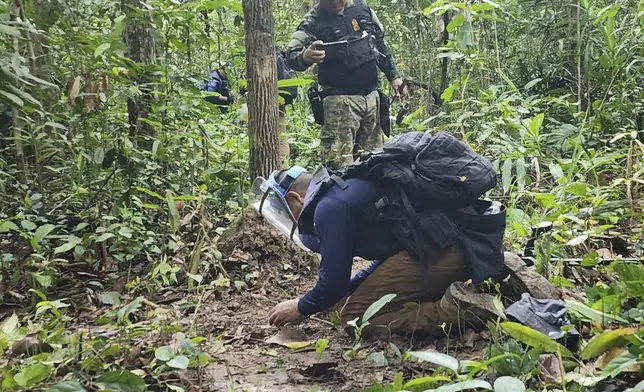 In this Sunday, July, 2025, photo released by the Royal Thai Army, Thai soldiers inspect a border area in Ubon Ratchathani†province where the Royal Thai Army said two anti-personnel landmines were found. (Royal Thai Army via AP)