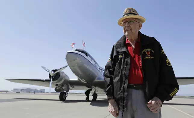 FILE - In this photo taken April 29, 2019, D-Day veteran Jake Larson poses before going for a ride in the "The Spirit of Benovia" World War II-era aircraft in Oakland, Calif. (AP Photo/Eric Risberg, file)
