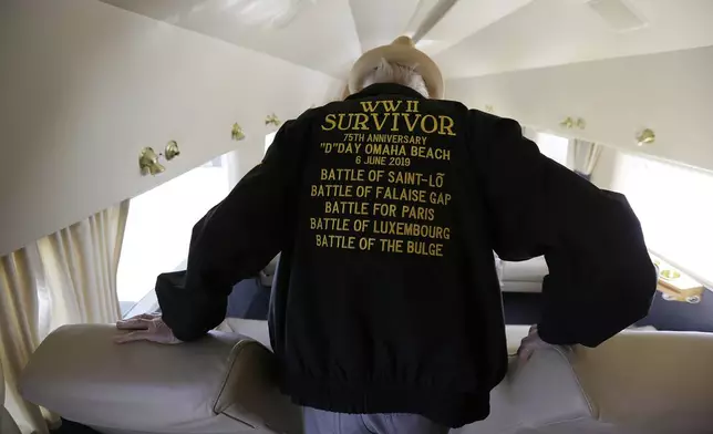 FILE - In this photo taken April 29, 2019, D-Day veteran Jake Larson walks to a seat before going for a ride in the "The Spirit of Benovia" WWII-era aircraft in Oakland, Calif. Both Larson and the former C-53 Skytrooper transport plane plan to be in Normandy, France and take part in events for the 75th anniversary of D-Day. (AP Photo/Eric Risberg, file)