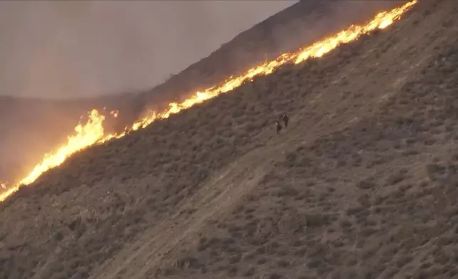In this image taken from video shows the Madre Fire in southeastern San Luis Obispo County, central Calif., July 2, 2025. (KEYT via AP)
