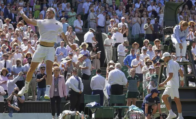 Julian Cash of Britain, left, celebrates with Lloyd Glasspool of Britain after winning the men's doubles final match against Rinky Hijikata of Australia and David Pel of the Netherlands at the Wimbledon Tennis Championships in London, Saturday, July 12, 2025. (AP Photo/Kin Cheung)