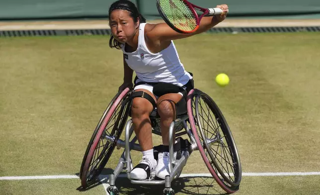 Yui Kamiji of Japan plays a return to Wang Ziying of China during the women's singles wheelchair final match at the Wimbledon Tennis Championships in London, Saturday, July 12, 2025.(AP Photo/Kirsty Wigglesworth)