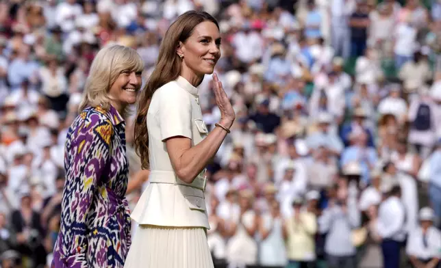 Britain's Kate, Princess of Wales gestures on centre court following the women's singles final between Poland's Iga Swiatek and Amanda Anisimova of the US at the Wimbledon Tennis Championships in London, Saturday, July 12, 2025. (Andrew Matthews/PA via AP)
