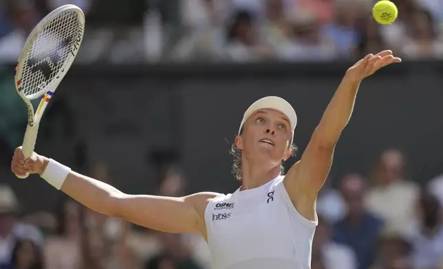Poland's Iga Swiatek serves to Amanda Anisimova of the U.S. during the women's singles final at the Wimbledon Tennis Championships in London, Saturday, July 12, 2025. (AP Photo/Kin Cheung)