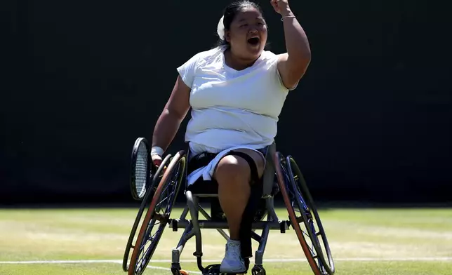 Wang Ziying of China celebrates after beating Yui Kamiji of Japan to win the final women's wheelchair singles match at the Wimbledon Tennis Championships in London, Saturday, July 12, 2025. (John Walton/PA via AP)