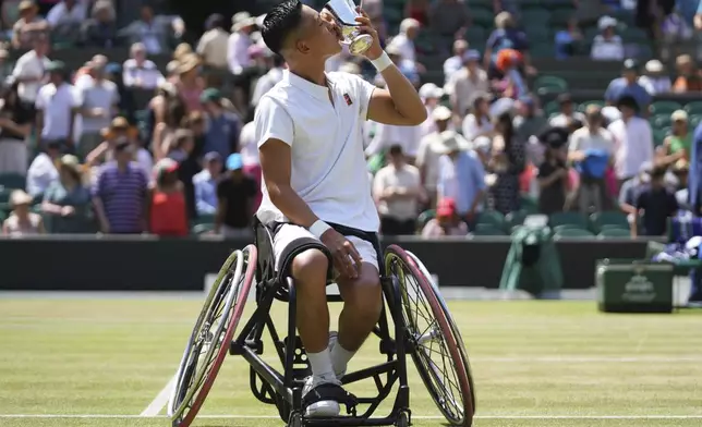 Tokito Oda of Japan kisses the trophy after winning the men's wheelchair singles final match against and Alfie Hewett of Britain at the Wimbledon Tennis Championships in London, Sunday, July 13, 2025.(AP Photo/Joanna Chan)