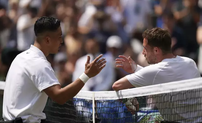 Tokito Oda of Japan, left, celebrates winning the men's wheelchair singles final match against and Alfie Hewett of Britain at the Wimbledon Tennis Championships in London, Sunday, July 13, 2025.(AP Photo/Joanna Chan)