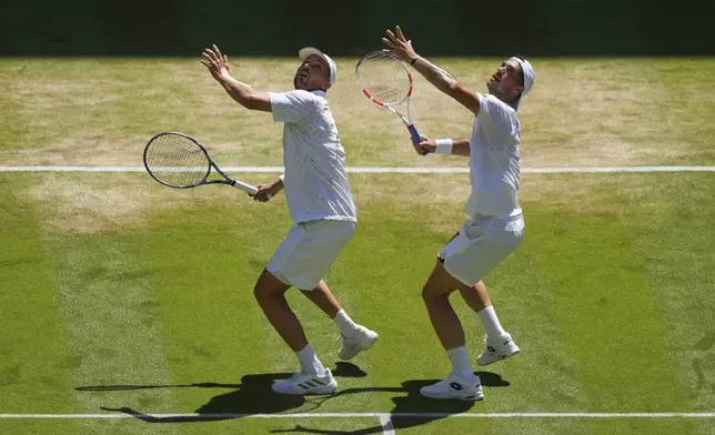 Julian Cash of Britain, right, and Lloyd Glasspool of Britain prepare to play a return during the men's doubles final match against Rinky Hijikata of Australia and David Pel of the Netherlands at the Wimbledon Tennis Championships in London, Saturday, July 12, 2025.(AP Photo/Joanna Chan)
