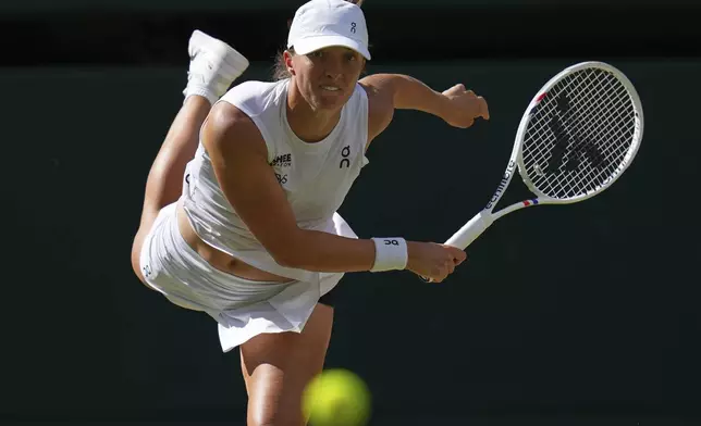 Iga Swiatek of Poland returns to Amanda Anisimova of the U.S. during the women's singles final match at the Wimbledon Tennis Championships in London, Saturday, July 12, 2025.(AP Photo/Kirsty Wigglesworth)