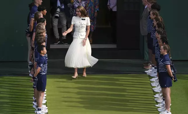 Britain's Kate, the Princess of Wales, arrives to hand over the trophy to Iga Swiatek of Poland after winning the women's singles final match against Amanda Anisimova of the U.S. at the Wimbledon Tennis Championships in London, Saturday, July 12, 2025.(AP Photo/Joanna Chan)