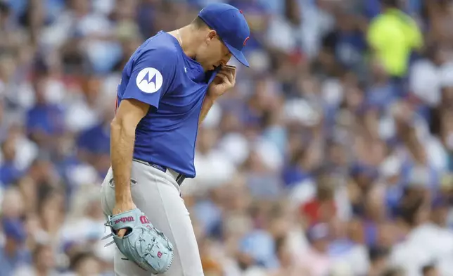 Chicago Cubs starting pitcher Matthew Boyd wipes his face during the third inning of a baseball game against the Milwaukee Brewers, Monday, July 28, 2025, in Milwaukee. (AP Photo/Jeffrey Phelps)