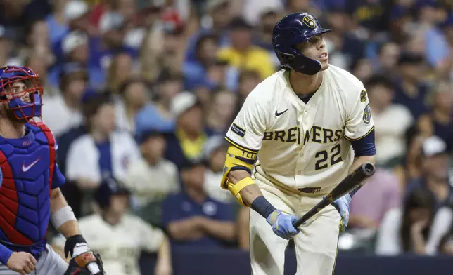 Milwaukee Brewers' Christian Yelich (22) watches his two-run home run against the Chicago Cubs during the seventh inning of a baseball game, Monday, July 28, 2025, in Milwaukee. (AP Photo/Jeffrey Phelps)