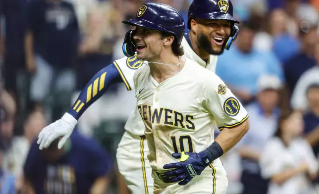 Milwaukee Brewers' Sal Frelick (10) reacts with Jackson Chourio, right, after his home run against the Chicago Cubs during the sixth inning of a baseball game, Monday, July 28, 2025, in Milwaukee. (AP Photo/Jeffrey Phelps)