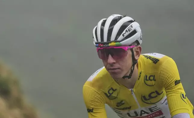 Slovenia's Tadej Pogacar, wearing the overall leader's yellow jersey, speeds down Aspin pass during the fourteenth stage of the Tour de France cycling race over 182.6 kilometers (113.5 miles) with start in Pau and finish in Luchon Superbagneres, France, Saturday, July 19, 2025. (AP Photo/Thibault Camus)