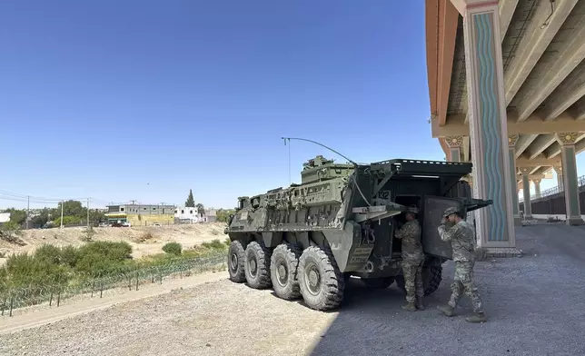 A military transport and surveillance vehicle is parked in a newly designated national defense area on June 11, 2025, along the southern U.S. border in El Paso, Texas. (AP Photo/Morgan Lee)
