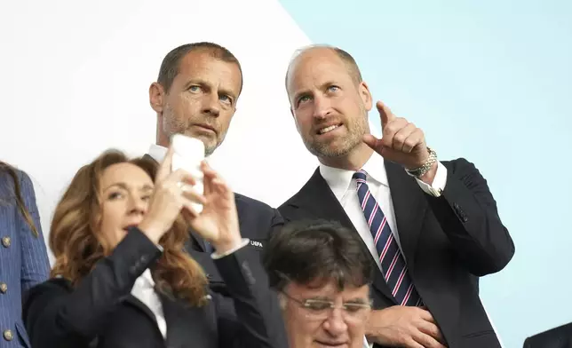 Britain's Prince William speaks to UEFA president Aleksander Ceferin, left, before the Women's Euro 2025 final soccer match between England and Spain at St. Jakob-Park in Basel, Switzerland, Sunday, July 27, 2025. (AP Photo/Alessandra Tarantino)