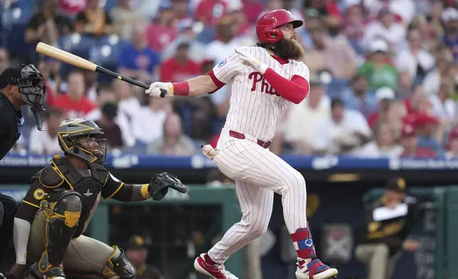 Philadelphia Phillies' Brandon Marsh follows through after hitting a home run against San Diego Padres pitcher Dylan Cease during the fifth inning in the second baseball game of a doubleheader Wednesday, July 2, 2025, in Philadelphia. (AP Photo/Matt Slocum)