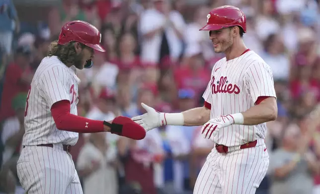 Philadelphia Phillies' Max Kepler, right, and Alec Bohm celebrate after Kepler's two-run home run during the fourth inning in the second baseball game of a doubleheader against the San Diego Padres Wednesday, July 2, 2025, in Philadelphia. (AP Photo/Matt Slocum)