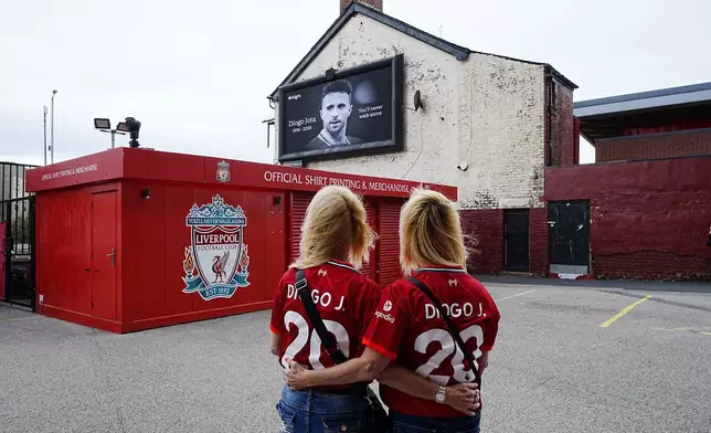 Liverpool supporters wearing shirts in memory of Diogo Jota at Anfield Stadium, home of Liverpool, who has died at the age of 28, in Liverpool, England, Friday July 4, 2025. (Peter Byrne/PA via AP)