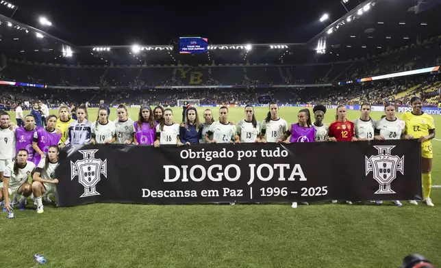 Portugal's players hold a banner with the words "Thank you for everything. Rest in peace." for Portuguese soccer player Diogo Jota who died in a car accident in Spain, after the Euro 2025, group B, soccer match between Spain and Portugal at Stadion Wankdorf in Bern, Switzerland, Thursday, July 3, 2025. (Peter Klaunzer/Keystone via AP)