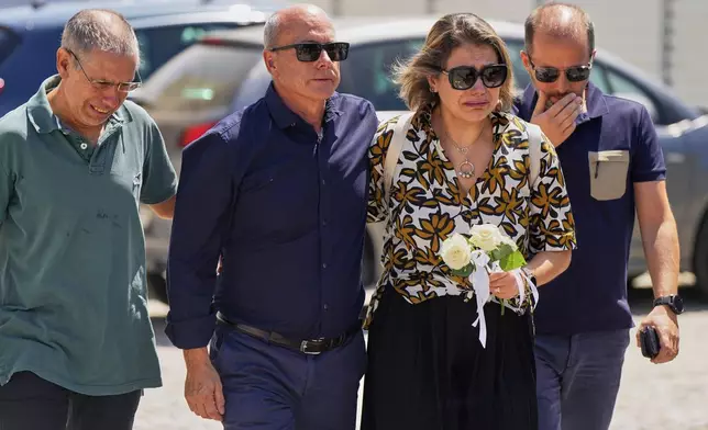 Joaquim, center, father of Liverpool forward Diogo Jota and his brother, arrives accompanied by other relatives at a church where their bodies have been brought for a wake and funeral, in Gondomar, near Porto, Portugal, on Friday, July 4, 2025. (AP Photo/Manu Fernandez)