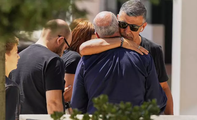Joaquim, center, father of Liverpool forward Diogo Jota and his brother, is embraced at a church where their bodies have been brought for a wake and funeral, in Gondomar, near Porto, Portugal, on Friday, July 4, 2025. (AP Photo/Manu Fernandez)