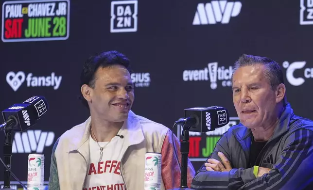 FILE - Boxers Cesar Chavez Jr,, left, smiles towards his father Julio Cesar Chavez, Mexico's former world champion, during a boxing news conference at the Avalon Hollywood Theatre in Los Angeles, May 14, 2025. (AP Photo/Damian Dovarganes, File)