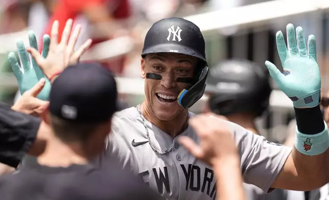 New York Yankees' Aaron Judge (99) celebrates his solo home run against the Atlanta Braves in the first inning of a baseball game, Sunday, July 20, 2025, in Atlanta. (AP Photo/Mike Stewart)