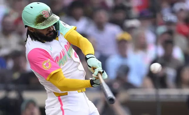 San Diego Padres' Fernando Tatis Jr. hits an RBI single during the second inning of a baseball game against the Philadelphia Phillies, Friday, July 11, 2025, in San Diego. (AP Photo/Orlando Ramirez)