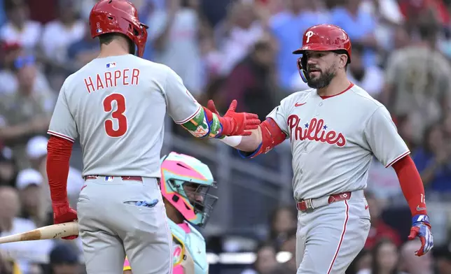 Philadelphia Phillies' Kyle Schwarber, right, is congratulated by Bryce Harper after hitting a home run during the third inning of a baseball game against the San Diego Padres, Friday, July 11, 2025, in San Diego. (AP Photo/Orlando Ramirez)