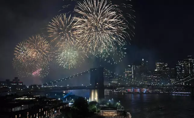 Fireworks light up the sky above the Brooklyn Bridge during Fourth of July celebrations on Friday, July 4, 2025, in New York. (AP Photo/Yuki Iwamura)