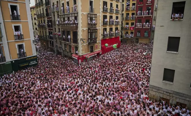 Revelers pack the main square during the start of nine days of celebrations in Pamplona's running-of-the-bulls festival in Pamplona, Spain, Sunday, July 6, 2025. (AP Photo/Miguel Oses)
