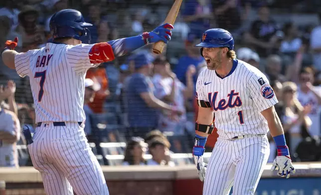 New York Mets' Jeff McNeil (1) celebrates with Brett Baty (7) after scoring on his two-run home run during the seventh inning of a baseball game against the New York Yankees, Friday, July 4, 2025, in New York. (AP Photo/Angelina Katsanis)
