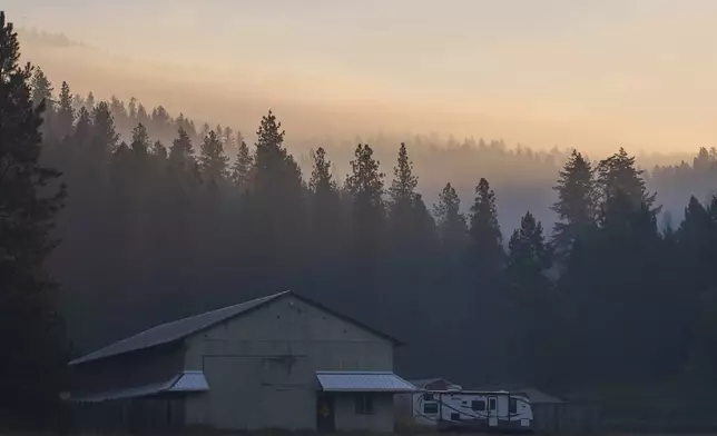 Smoke fills the air the day after a shooter ambushed and killed multiple firefighters responding to a wildfire at Canfield Mountain Monday, June 30, 2025, in Coeur D'Alene, Idaho. (AP Photo/Lindsey Wasson)